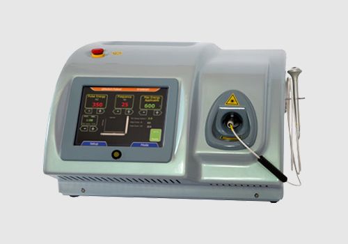 A medical laser device with a digital display, status indicators, and control buttons on the front panel.